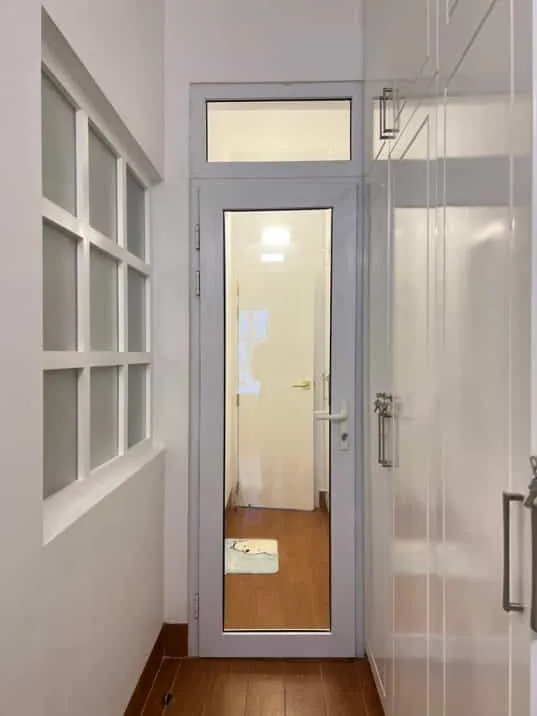 Glass-panel interior door beside white cabinetry