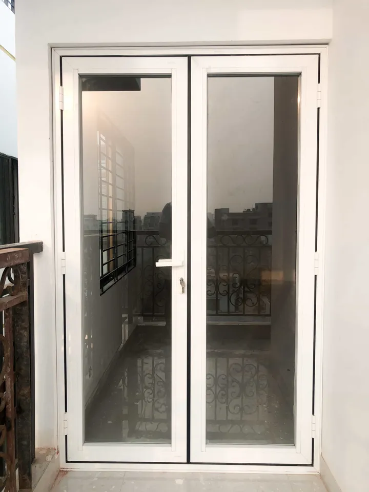 Pair of white-framed glass doors in a narrow interior opening