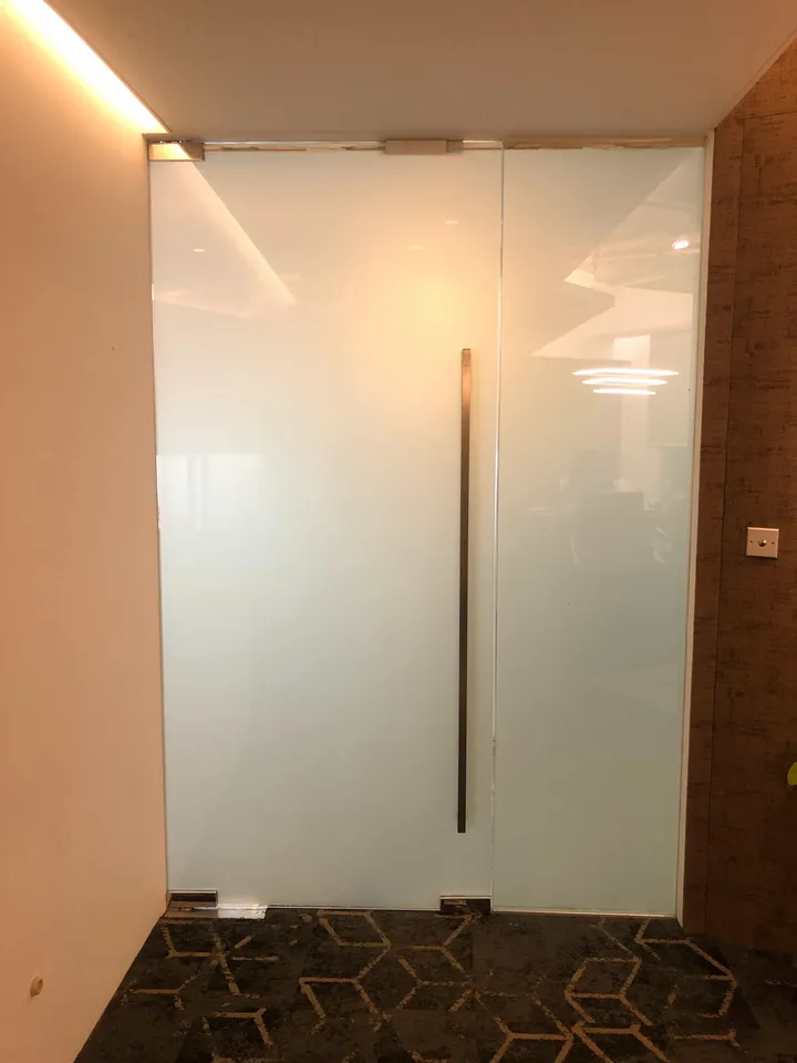 Frosted glass shower door with a long vertical handle
