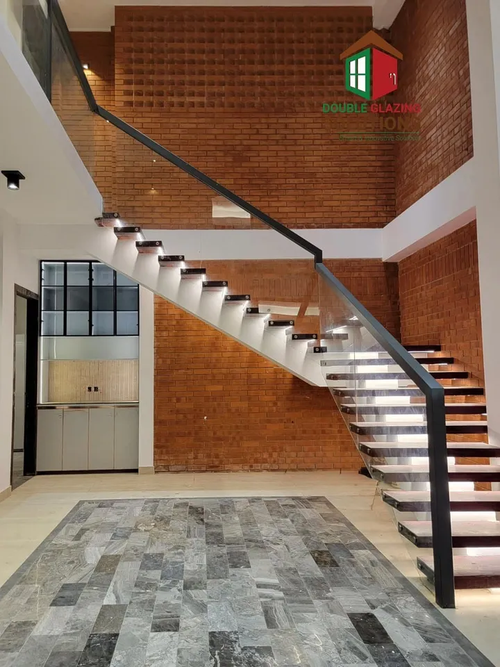 Curved staircase with transparent glass balustrade
