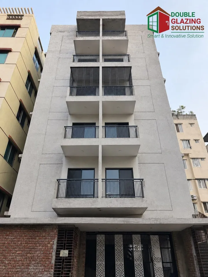 Tall urban building with white and gray façade panels