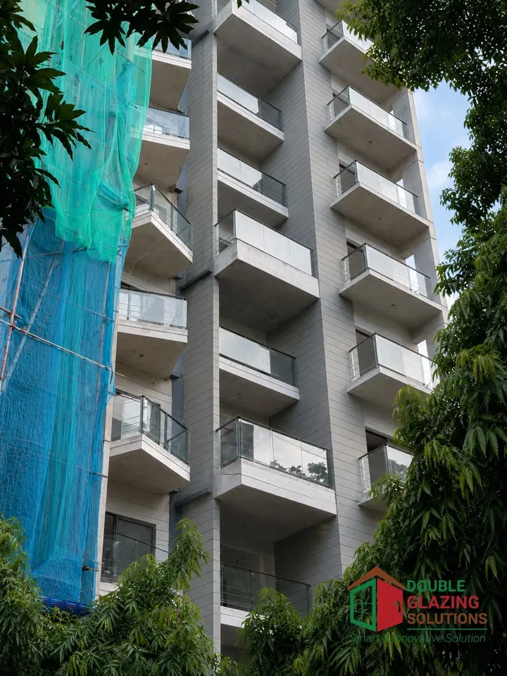 Residential façade viewed from below beside a tree