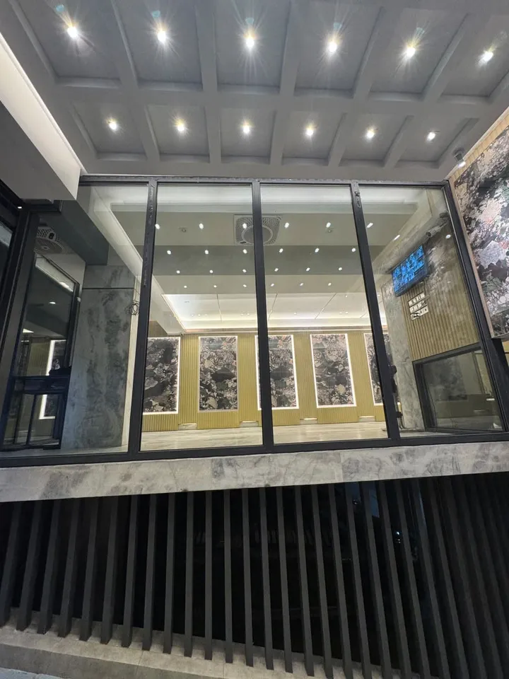 Dark-framed glazed enclosure with many small ceiling lights