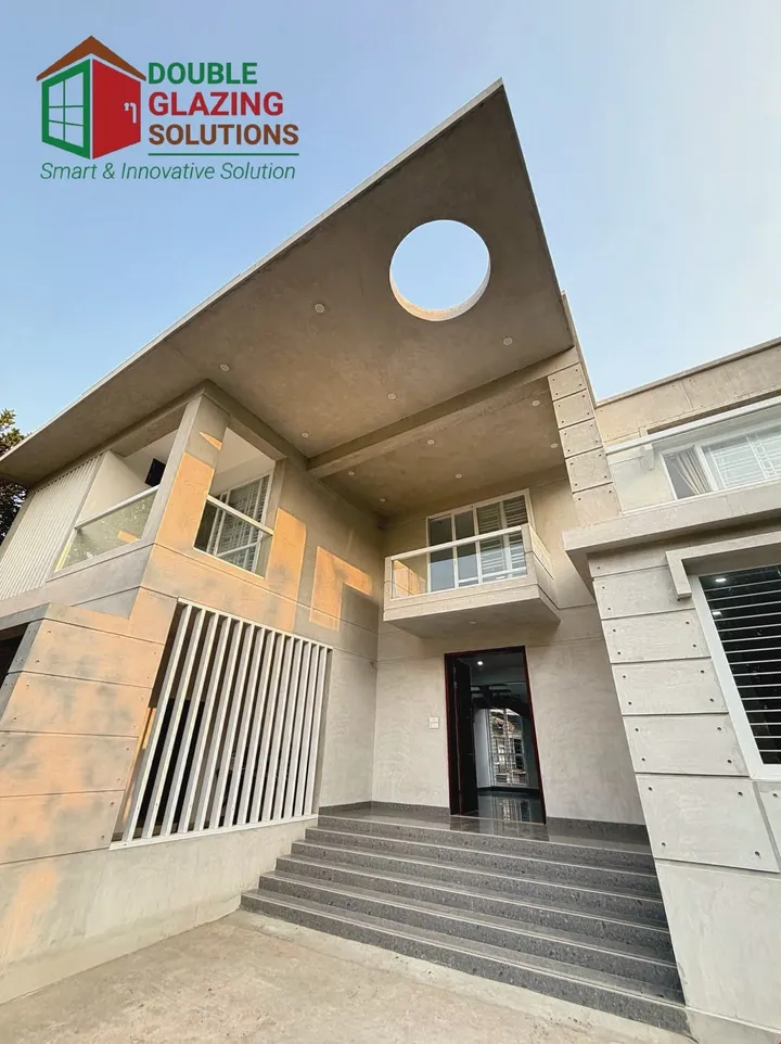 Angular building entrance with a circular opening in the roof plane