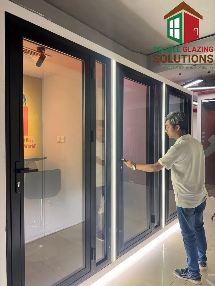 Person beside a broad dark-framed sliding glass opening