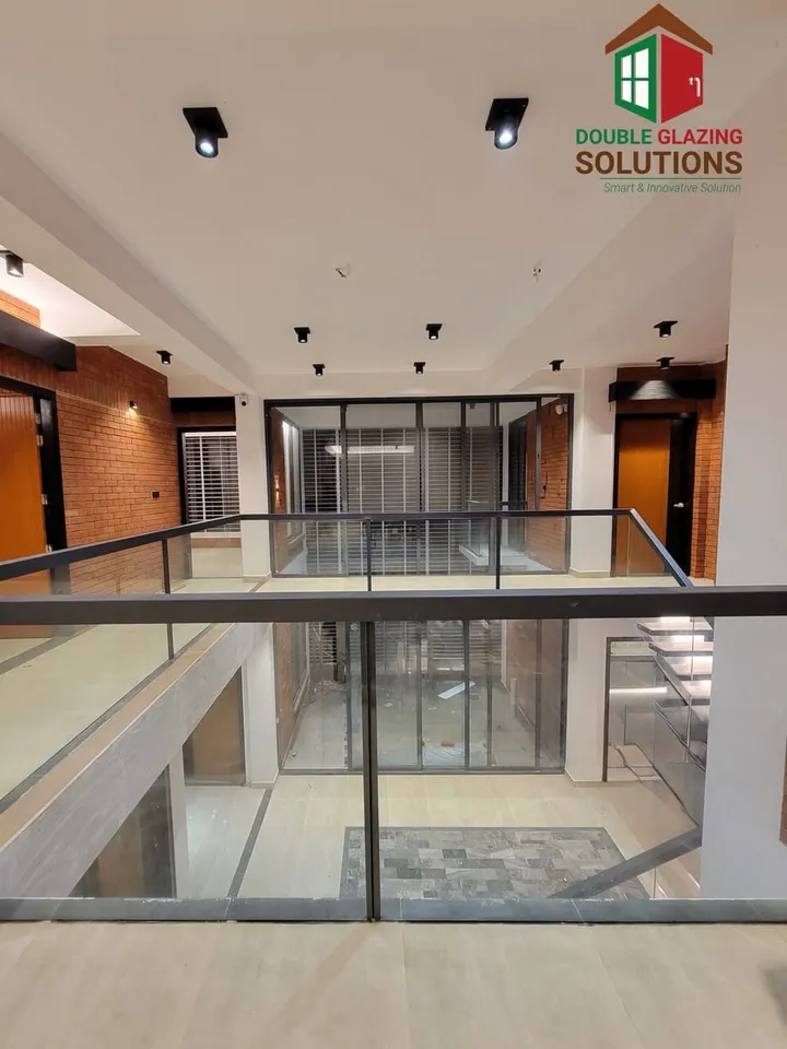Upper-floor landing with transparent glass balustrades