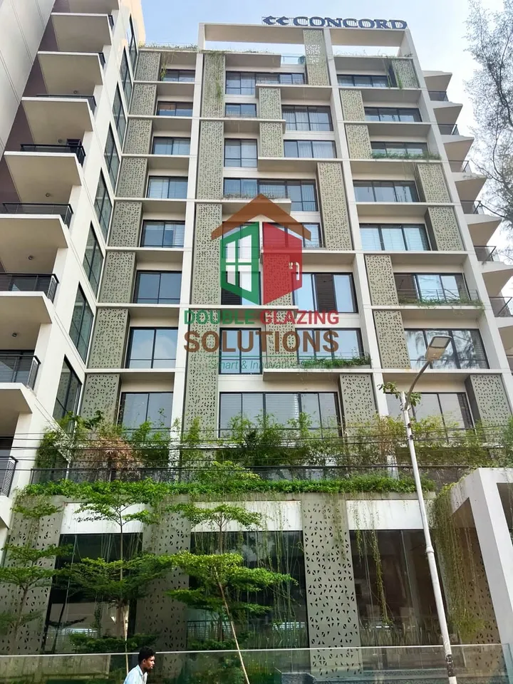 Front elevation with stacked windows, balconies and trees