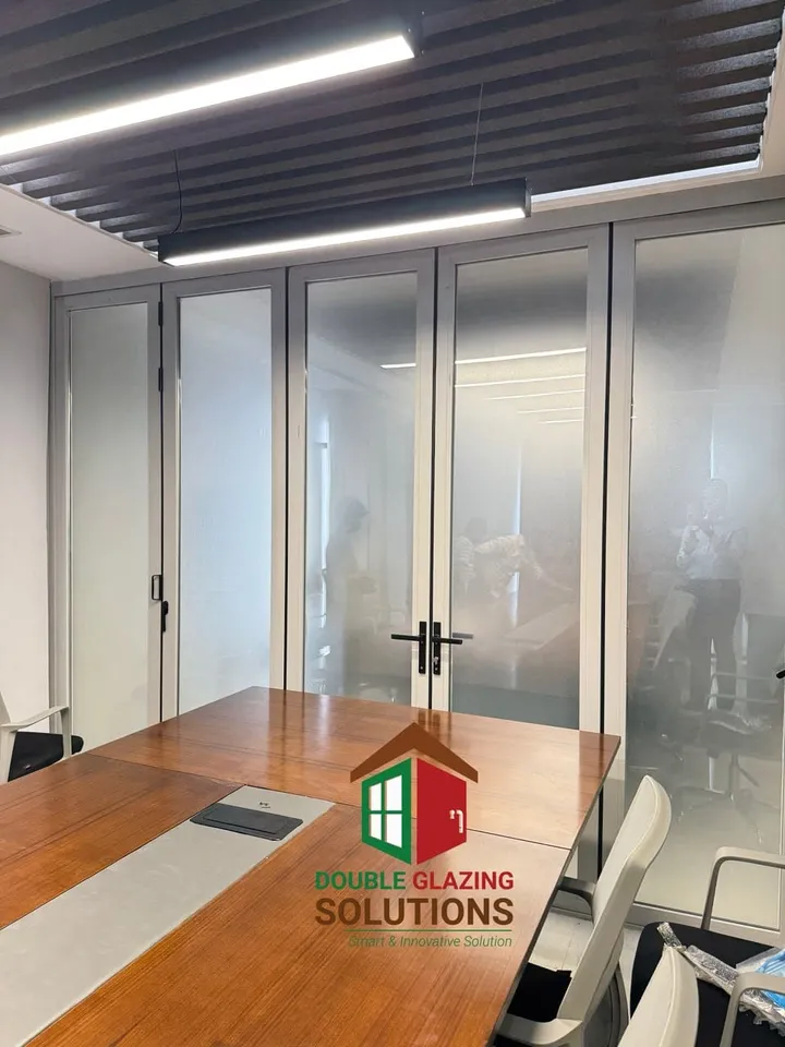 Bathroom with clear glass panels and warm floor tones