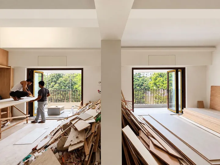 Partly finished interior with black-framed windows and construction materials